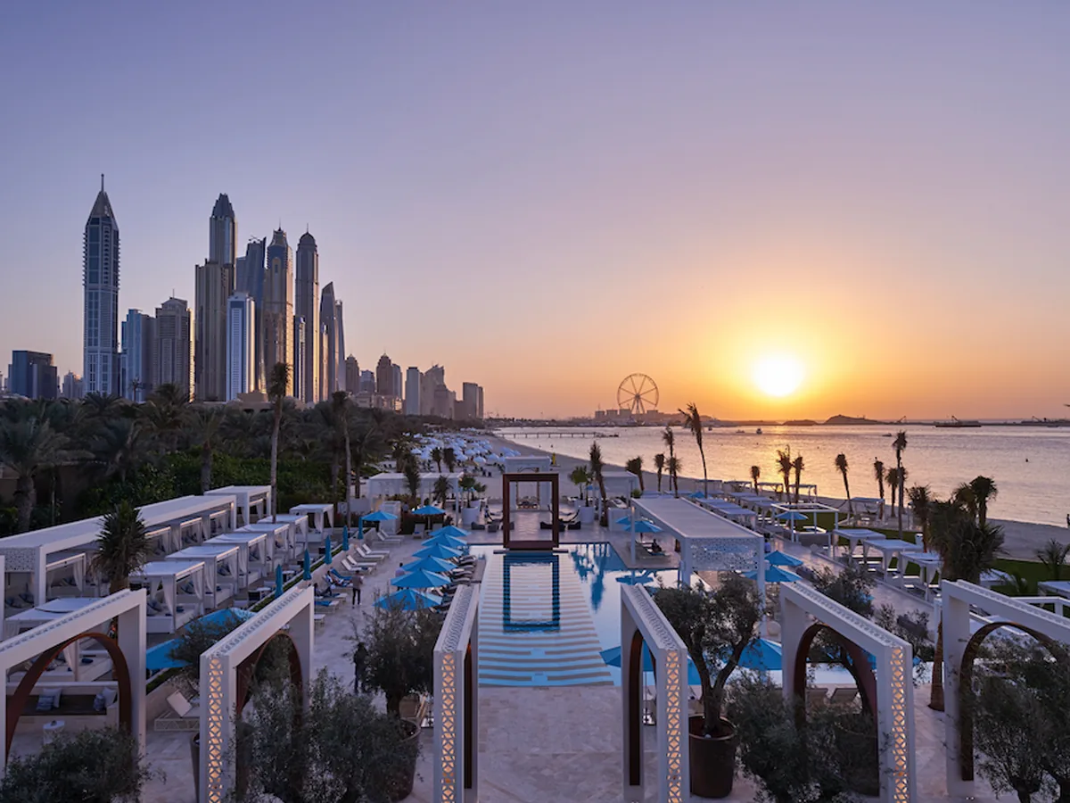 Luxury beach club in Dubai with infinity pool and skyline view at sunset
